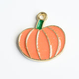 Orange glitter pumpkin charm with a green enamel stem